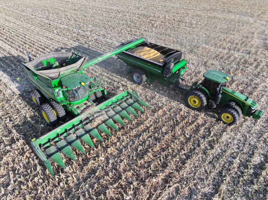 A tractor and trailer in the middle of a field.