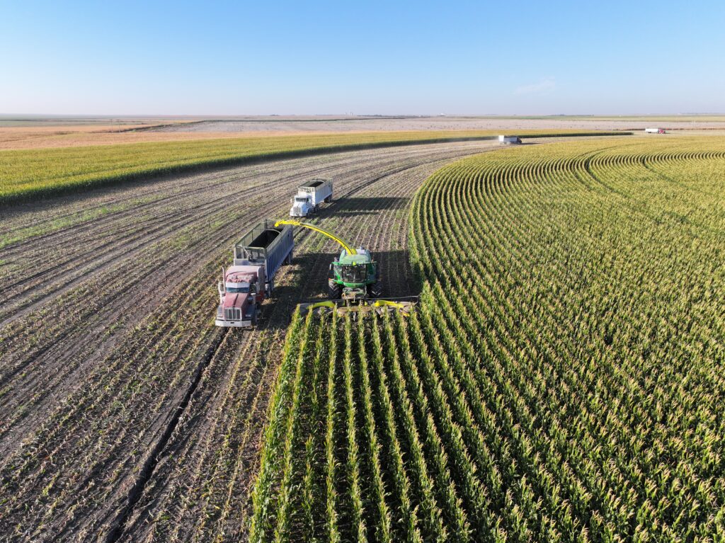 A tractor is in the middle of an open field.