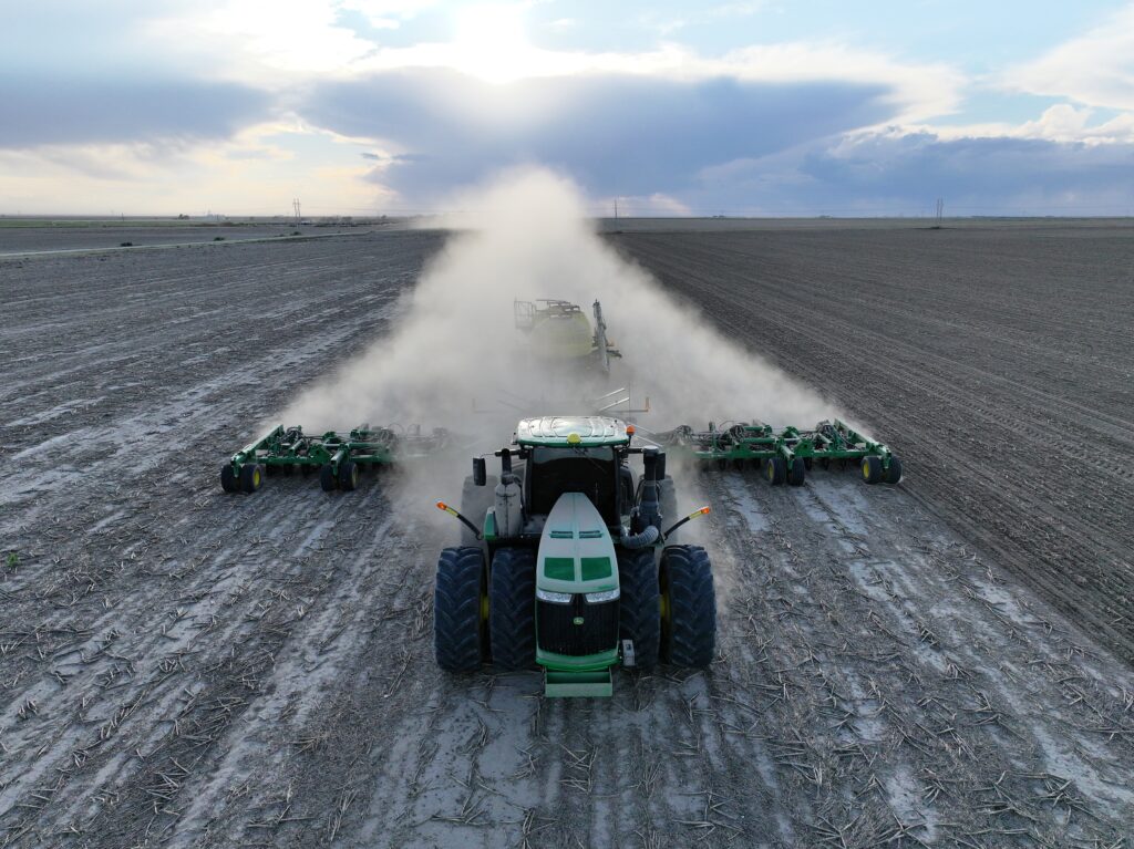 A tractor is pulling a large amount of dirt.