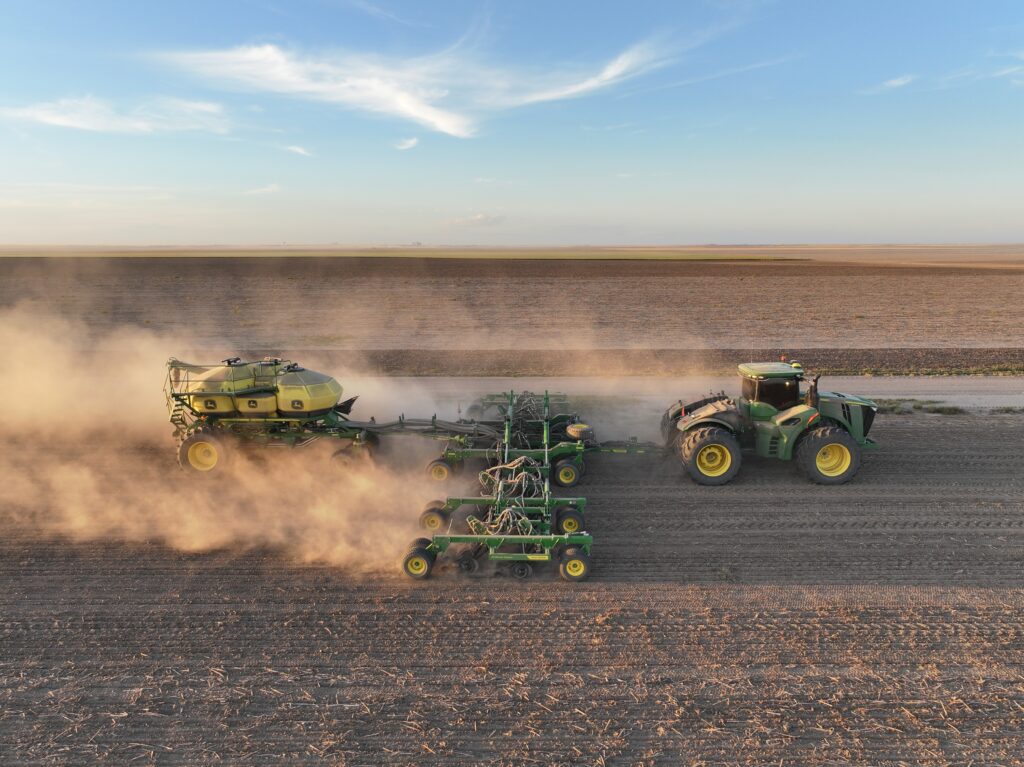 A tractor pulling a trailer on top of a field.