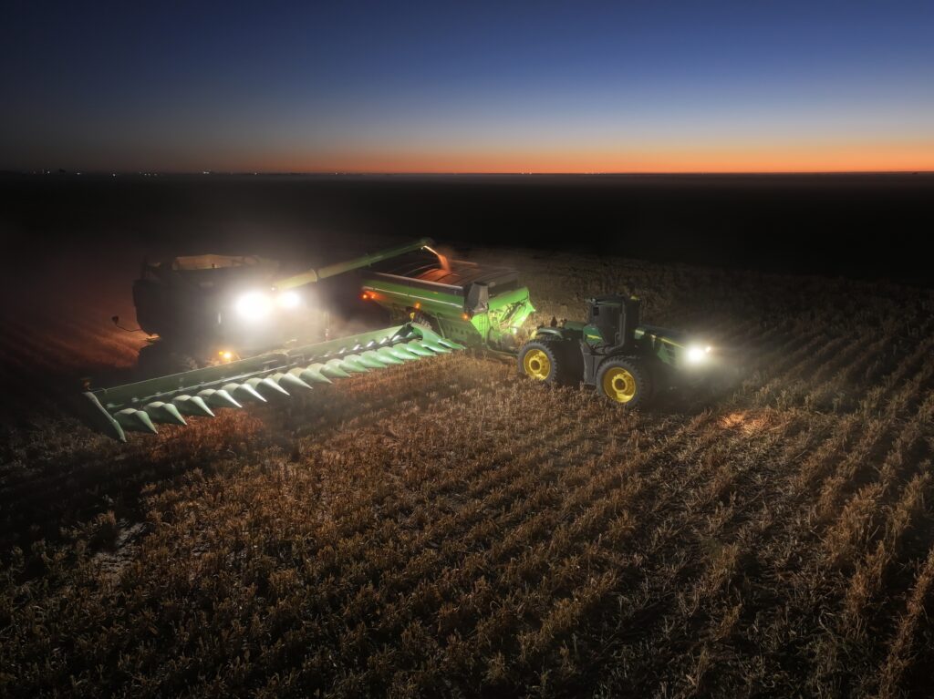 A tractor is pulling a trailer in the middle of a field.